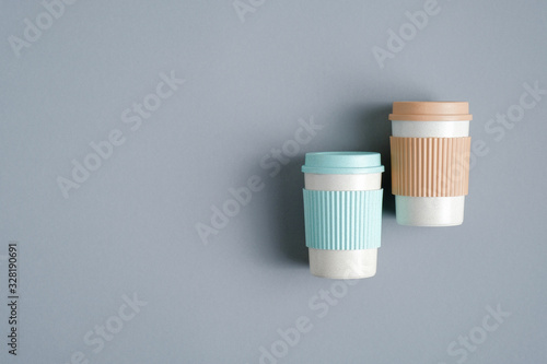 Reusable bamboo coffee cups or mugs on grey background  top view. Zero waste  plastic free concept