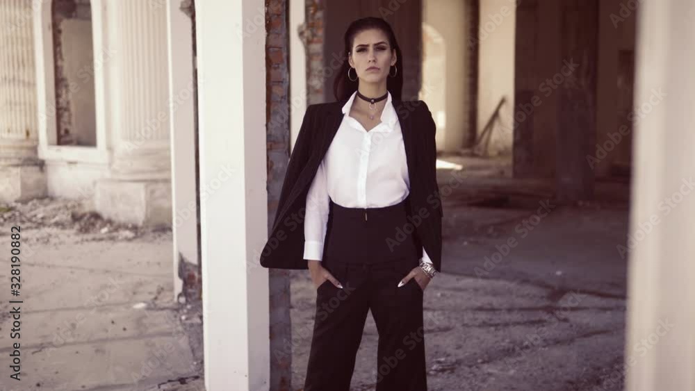fashionable model in pantsuit and white shirt standing on the terrace classic abandoned building posing fashionable model in pantsuit and white shirt standing on the terrace classic abandoned building posing