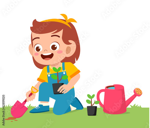 happy cute little kid girl plant tree in garden