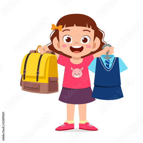 happy cute little kid girl preparing uniform for school
