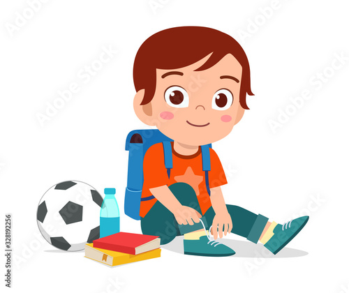 happy cute little kid boy tie shoe