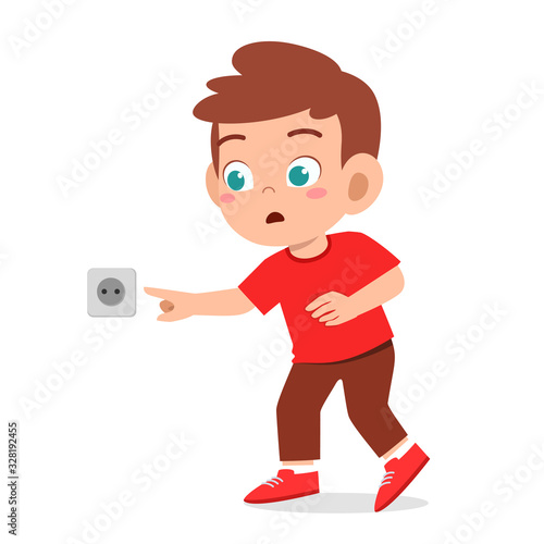 curious little kid boy play with electicity socket
