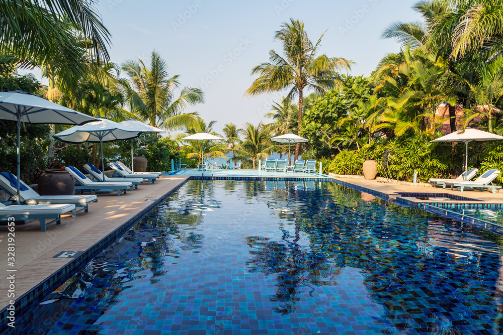 beautiful swimming pool in tropical resort coconut palm tree