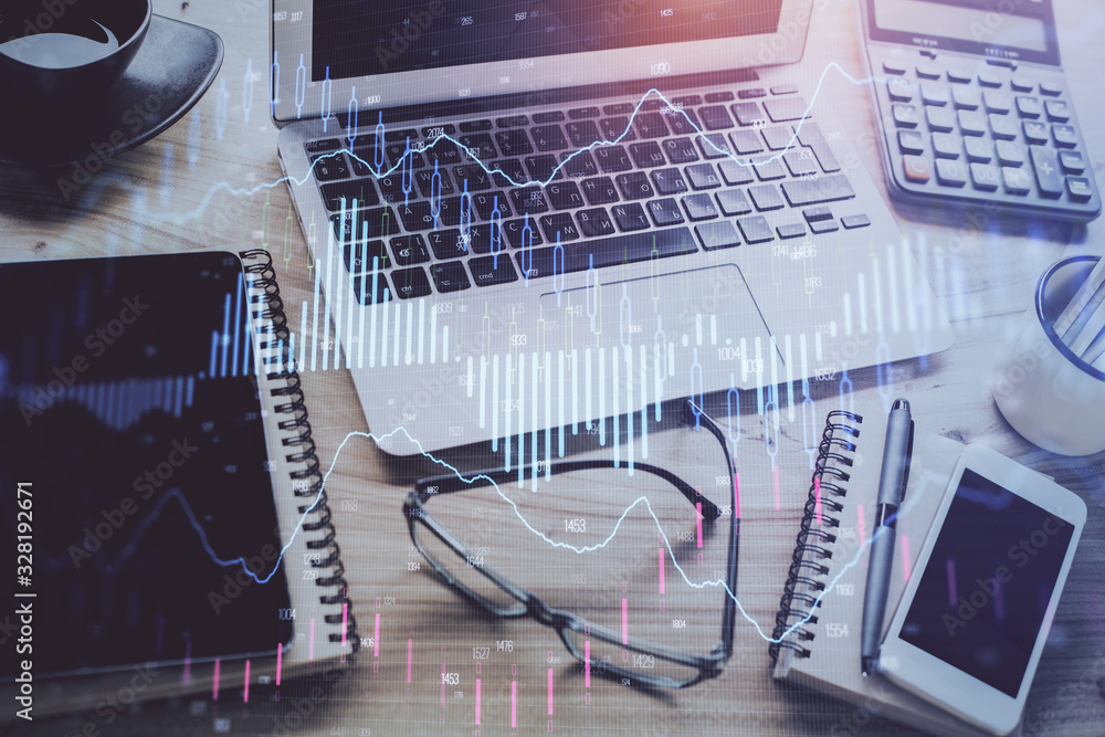 Forex market graph hologram and personal computer on background. Multi exposure. Concept of investment. Forex market graph hologram and personal computer on background. Multi exposure. Concept of investment.