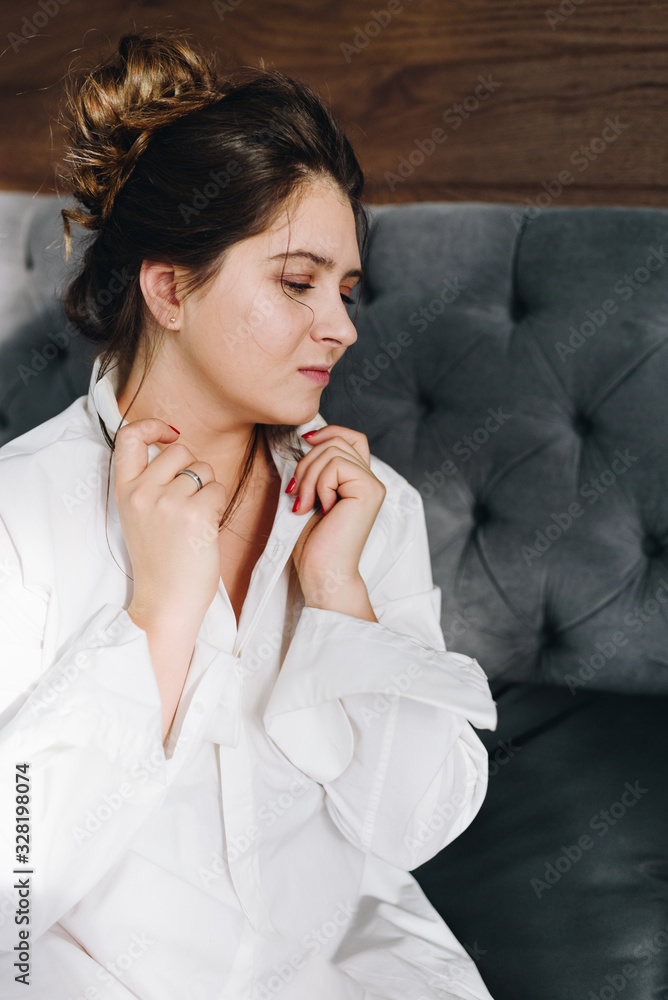 Young sexy woman in mens shirt in the bedroom Young sexy woman in mens shirt in the bedroom