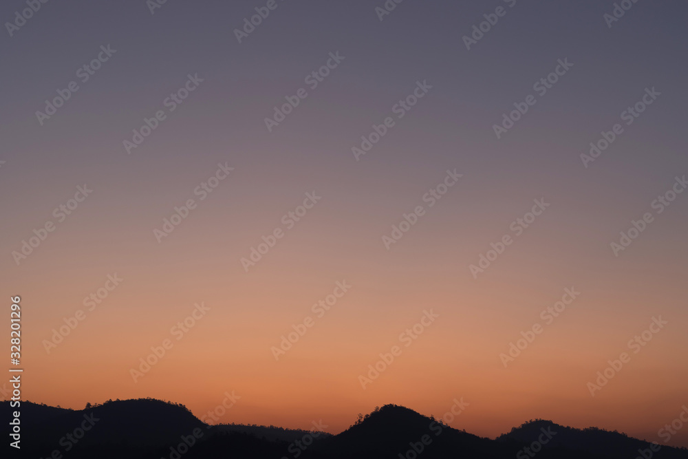 Heaven at early morning with copy space. Smooth orange blue gradient of dawn sky.Sunset, sunrise backdrop.Predawn clear sky with orange horizon and blue atmosphere. Background of beginning of day. Heaven at early morning with copy space. Smooth orange blue gradient of dawn sky.Sunset, sunrise backdrop.Predawn clear sky with orange horizon and blue atmosphere. Background of beginning of day.