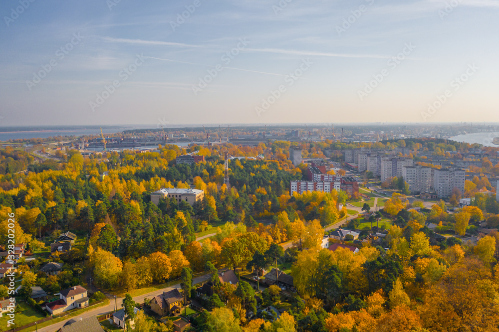 Riga, Latvia –  October 3 2019: Beautiful Aerial panoramic view photo from flying drone of Vecmilgravis district in beautiful autumn sunset in Riga, Latvia