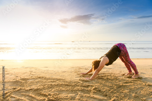 Woman yoga on the beach