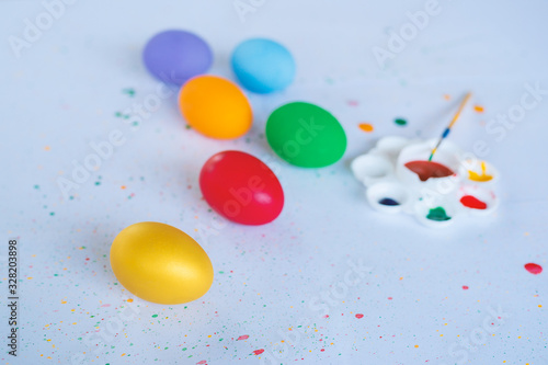 Colorful eggs on white paper Complete with color palettes and paintbrush. Art and Easter concept. © nitinai2518