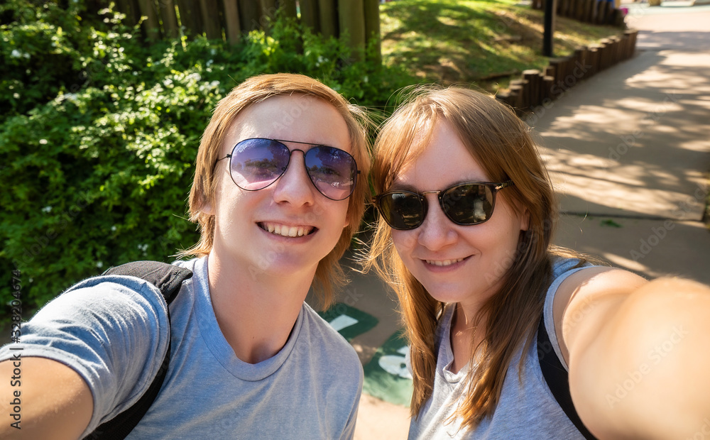 Selfie portrait of happy brother with sister in the park