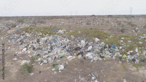 Left traveling aerial drone view move of garbage in the Sechura Desert in Lambayeque Region, Peru photo