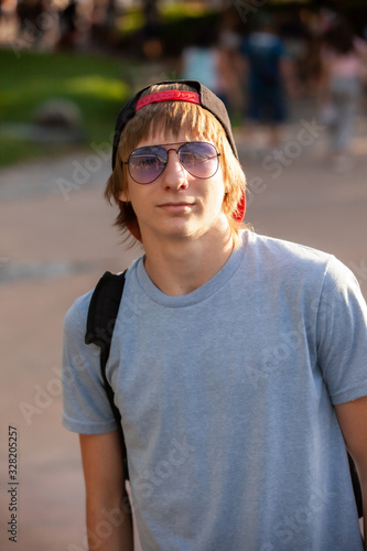 Portrait, teenage student outdoors in a park