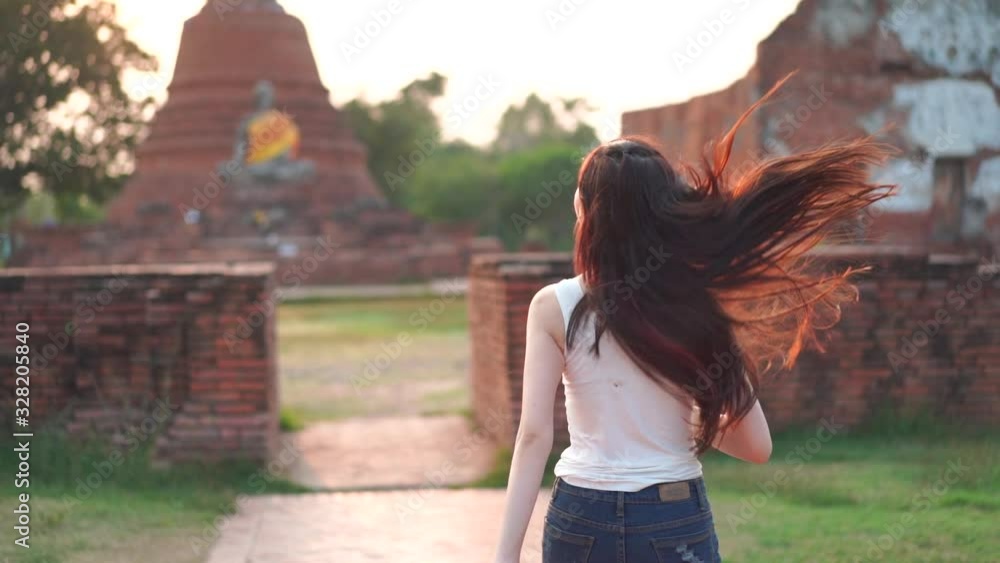 Freedom Asian female enjoying and happy while travel at An archaeological in Ayutthaya Historical Park Ayutthaya Province, Thailand. Freedom Asian female enjoying and happy while travel at An archaeological in Ayutthaya Historical Park Ayutthaya Province, Thailand.