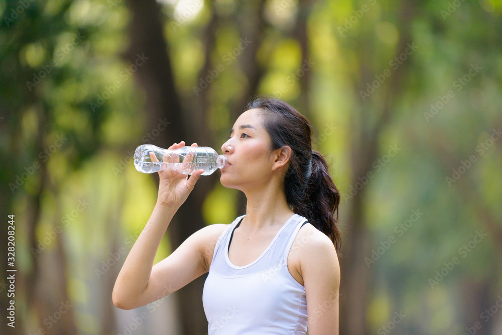 Young Asian woman and a bottle of water Young Asian woman and a bottle of water