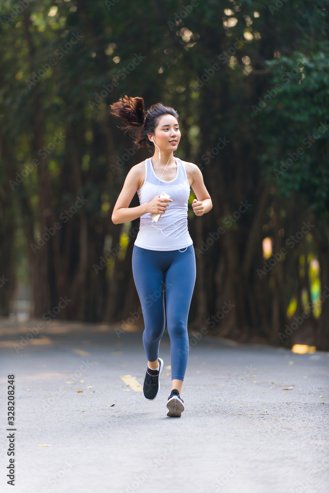 Young woman running in a park Young woman running in a park