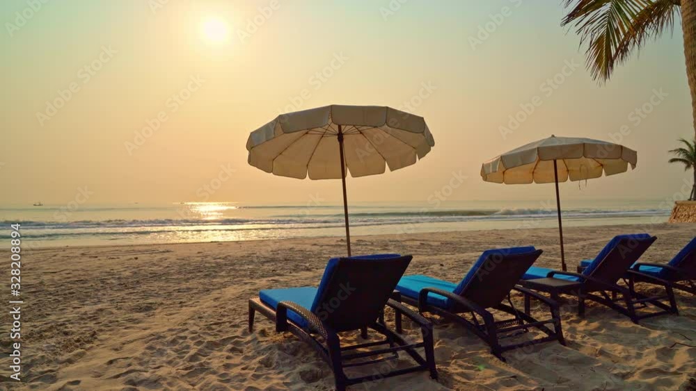 umbrella chair beach with palm tree and sea beach at sunrise times umbrella chair beach with palm tree and sea beach at sunrise times