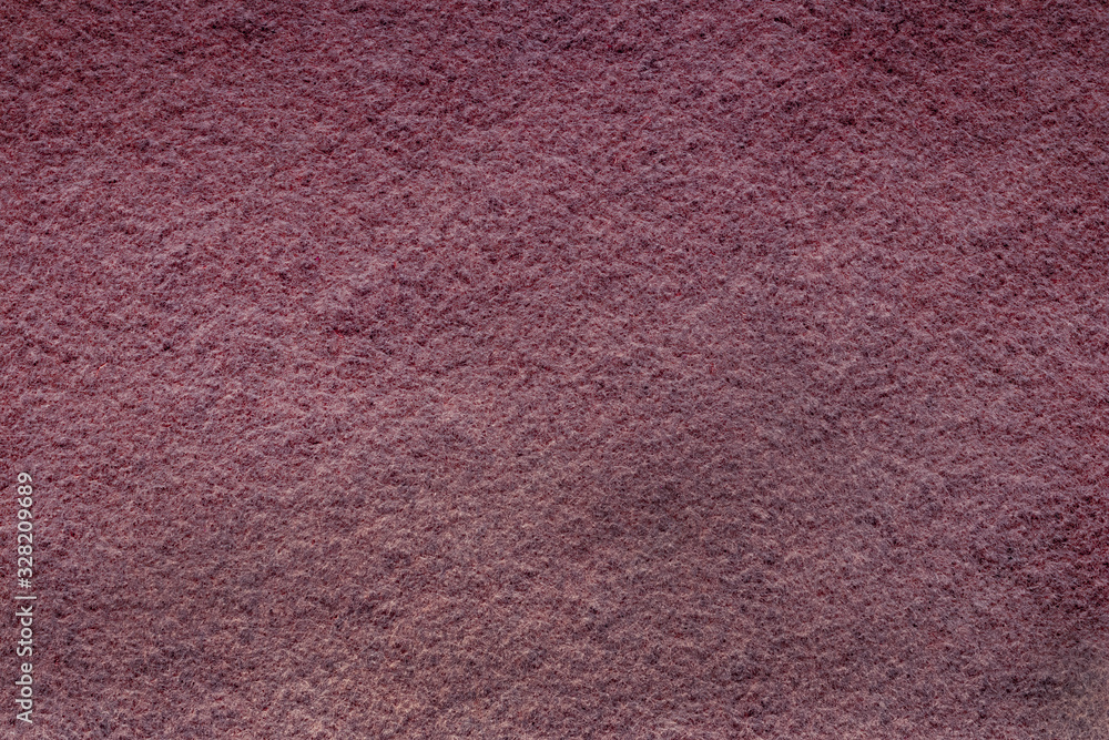 Fototapeta premium Abstract background with brown texture, velvet fabric, close-up. Colorful felt texture for background with copy space. Felt fabric sheet