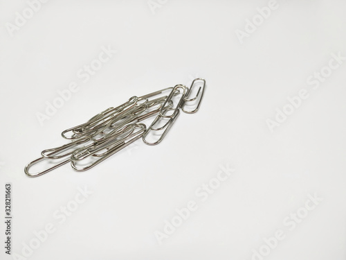 Small pile of paper clips. Silver design isolated on white background.