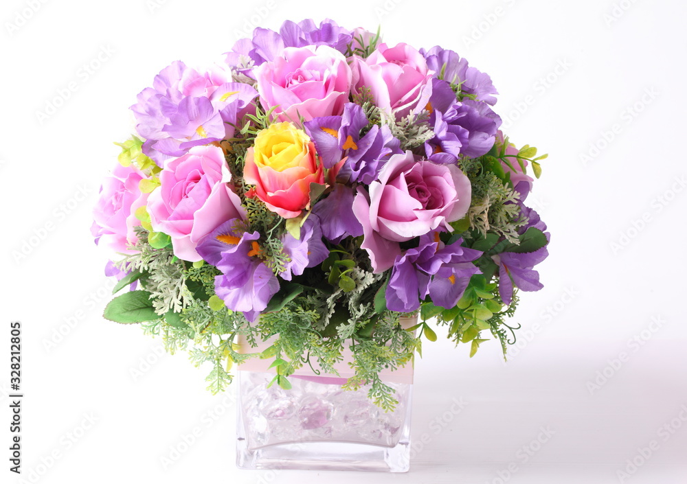 Colorful flower arrangement centerpiece in square glass vase Colorful flower arrangement centerpiece in square glass vase