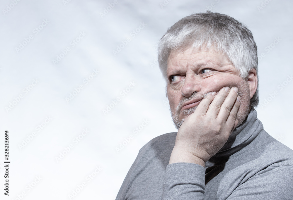 Portrait of an older man. He rested his head thoughtfully on one hand. Portrait of an older man. He rested his head thoughtfully on one hand.
