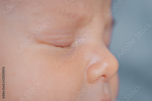newborn baby's face close up: eyes, nose, lips. concept of childhood, health care, IVF, hygiene, ENT
