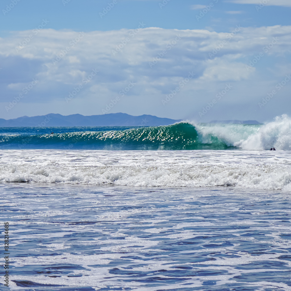 Fototapeta premium Beautiful aerial view of surfers surfing in Naranjo Beach 