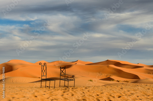 Metal chairs of Auberge du Sud in the sand dune desert of Erg Chebbi Morocco