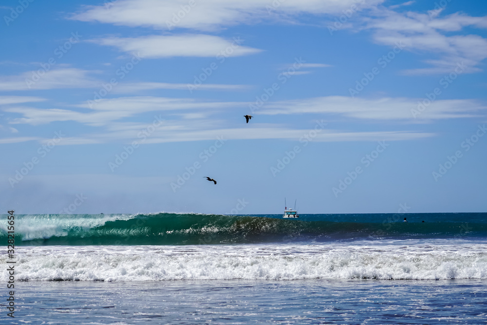 Beautiful aerial view of surfers surfing in Naranjo Beach Beautiful aerial view of surfers surfing in Naranjo Beach