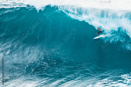 Fototapeta Naklejka Na Ścianę i Meble -  A lone surfer enjoying a big wave in Hawaii.