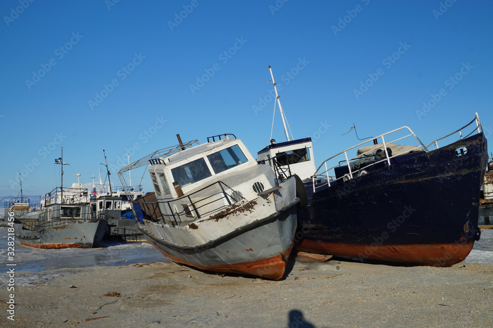 ships stand on the sand in the ice waiting for summer ships stand on the sand in the ice waiting for summer