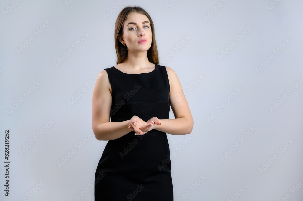 Universal concept. Photo of a pretty Caucasian business woman in a black dress on a white background. Universal concept. Photo of a pretty Caucasian business woman in a black dress on a white background.