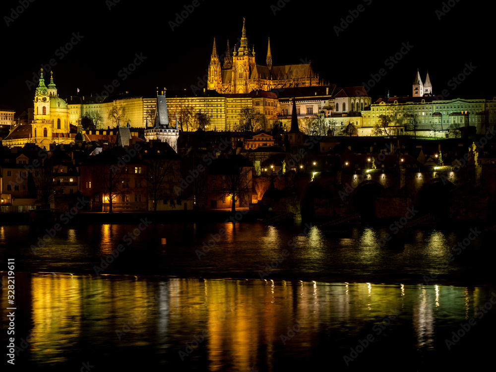 Prague, Czech Republic. Amazing landscape of the castle at night. In the foreground the Charles Bridge. View of historical buildings along the river