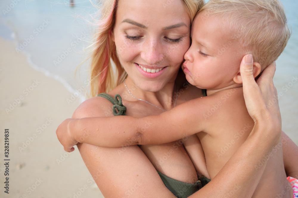 Pregnant mother and kid on the beach, happy mothers day Pregnant mother and kid on the beach, happy mothers day