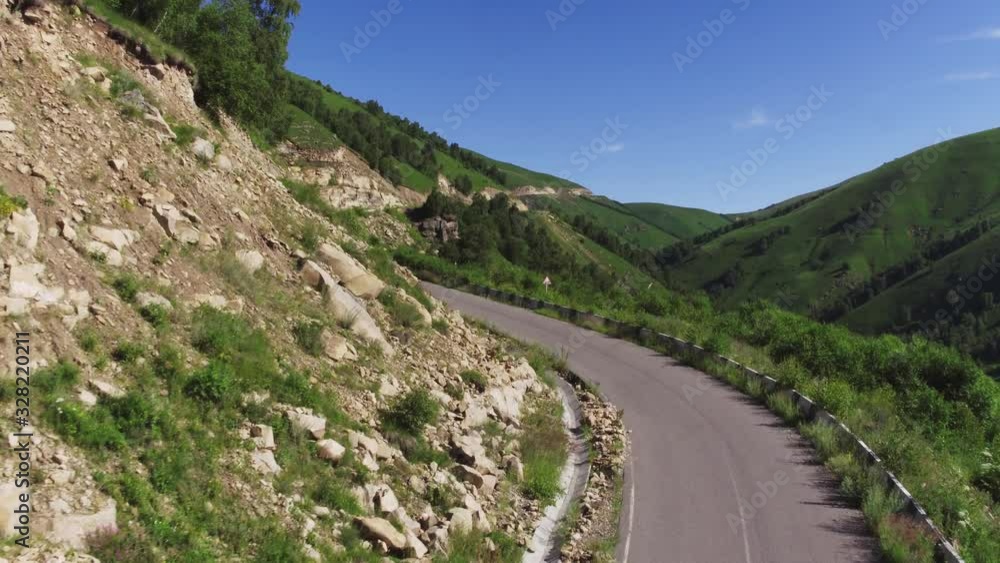 Empty serpentine road over cliff with fence, Kislovodsk - Dzhily Su asphalt dangerous beautiful winding freeway to Mount Elbrus in caucasus mountains at summer sunny morning - Aerial drone view Empty serpentine road over cliff with fence, Kislovodsk - Dzhily Su asphalt dangerous beautiful winding freeway to Mount Elbrus in caucasus mountains at summer sunny morning - Aerial drone view