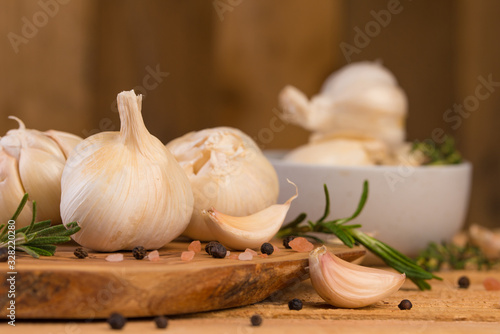 Fototapeta Naklejka Na Ścianę i Meble -  Garlic with rosemary and thyme and spices on a wooden background