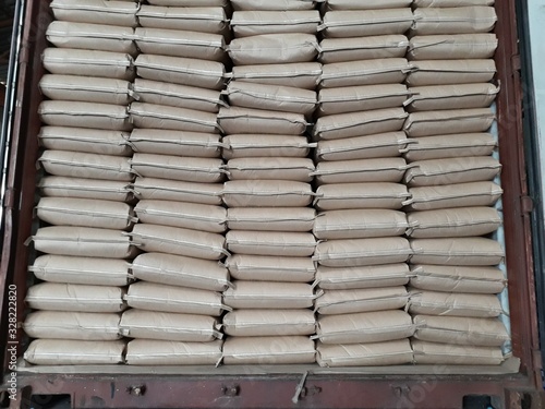 Chemical fertilizer The product stock is packed in sacks, stacked brown Inside the container in the warehouse, waiting for delivery.