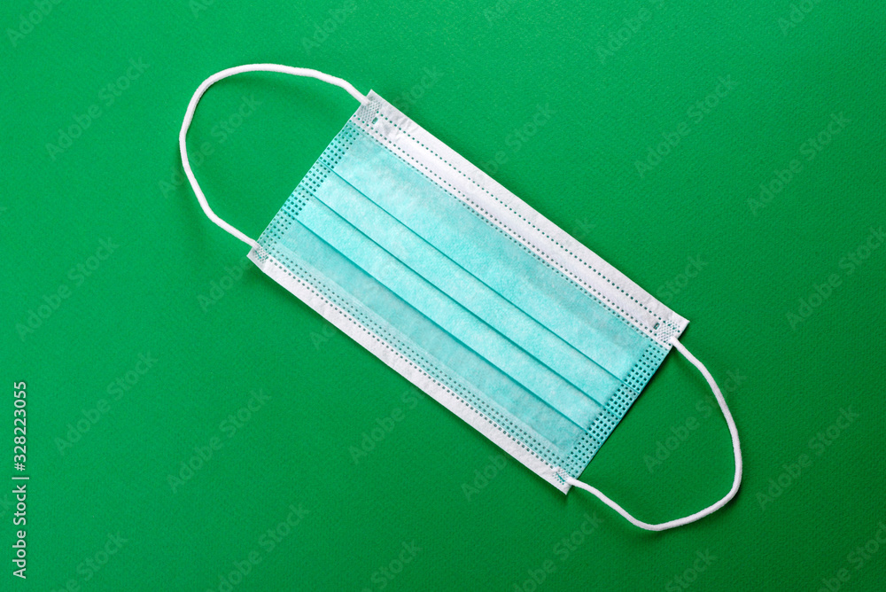 Medical mask on a colored background, a means of protection against coronovirus and epidemic Medical mask on a colored background, a means of protection against coronovirus and epidemic