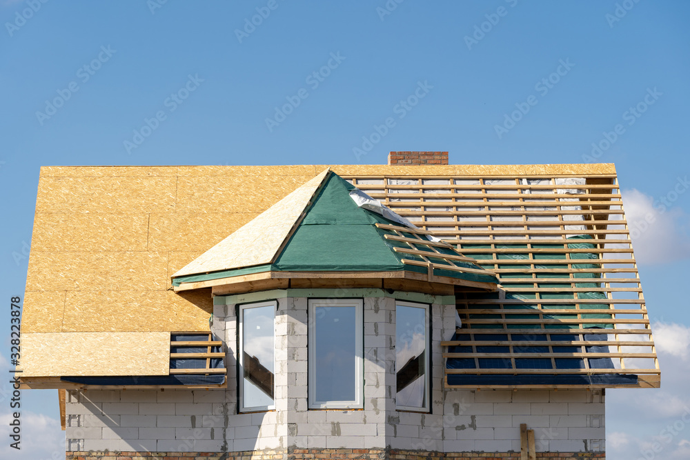 New house under construction with unfinished roof