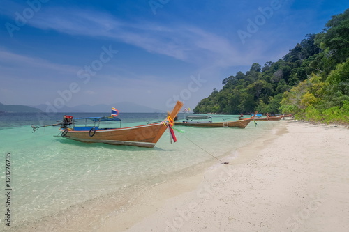 view seaside of a long-tail boat floating in blue-green sea and blue sky background  Monkey island  long-tail boat trip from Lipe island  Satun  southern Thailand.