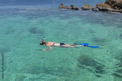 view of tourist snorkeling in blue-green sea around with many rocks background, Ko Jabang island, long-tail boat trip from Lipe island, Satun, southern Thailand.