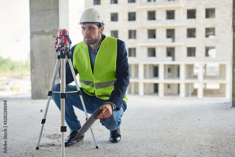 An engineers uses measuring equipment at his work place. An engineers uses measuring equipment at his work place.