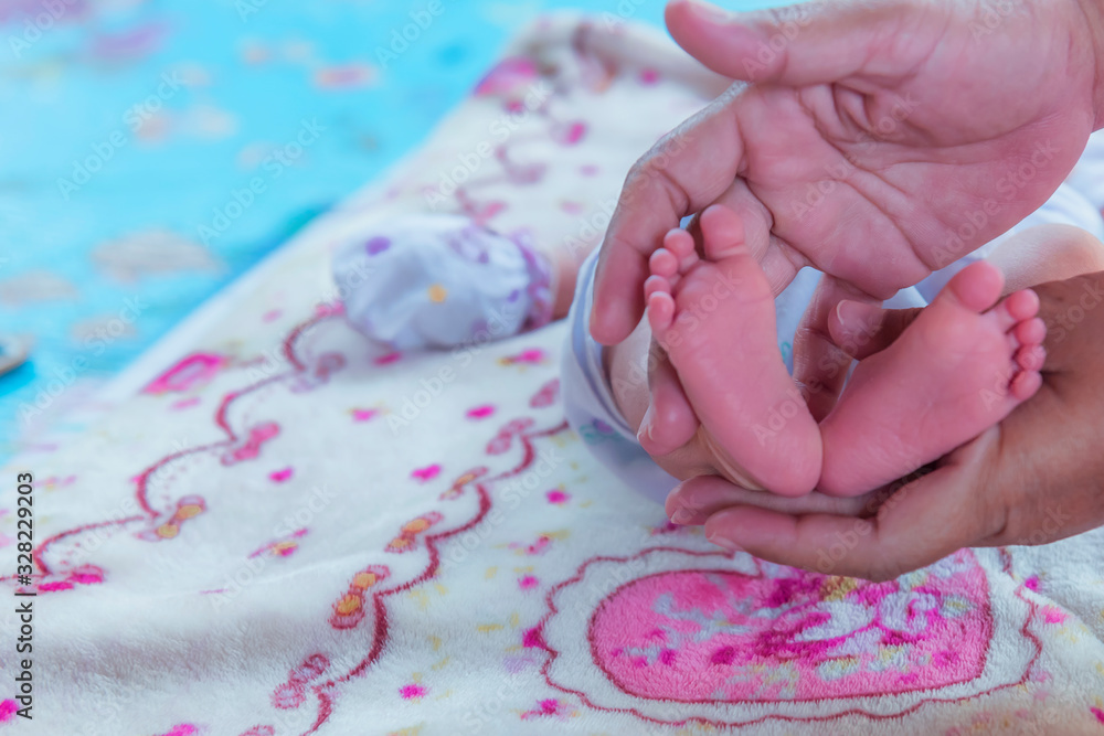 Baby feet in mother hands. Tiny Newborn Baby's feet on female Shaped hands closeup. Mom and her Child. Happy Family concept. Beautiful conceptual image of Maternity. Baby feet in mother hands. Tiny Newborn Baby's feet on female Shaped hands closeup. Mom and her Child. Happy Family concept. Beautiful conceptual image of Maternity.