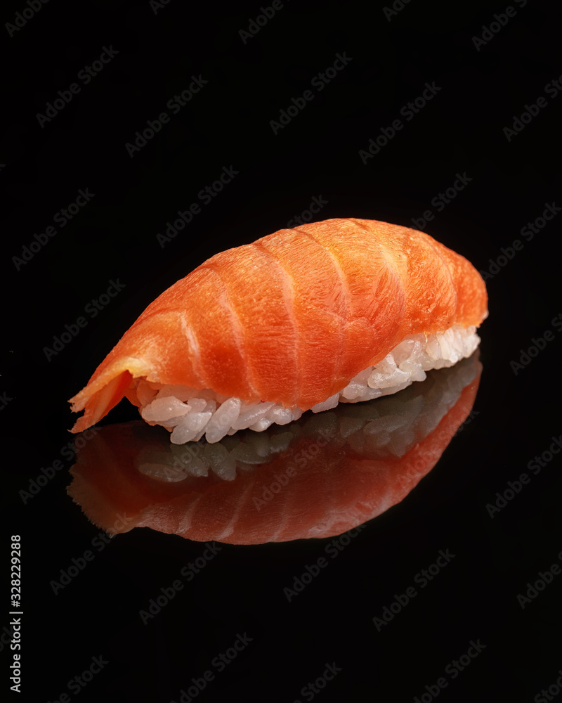 Traditional Japanese sushi on a black glossy background Traditional Japanese sushi on a black glossy background