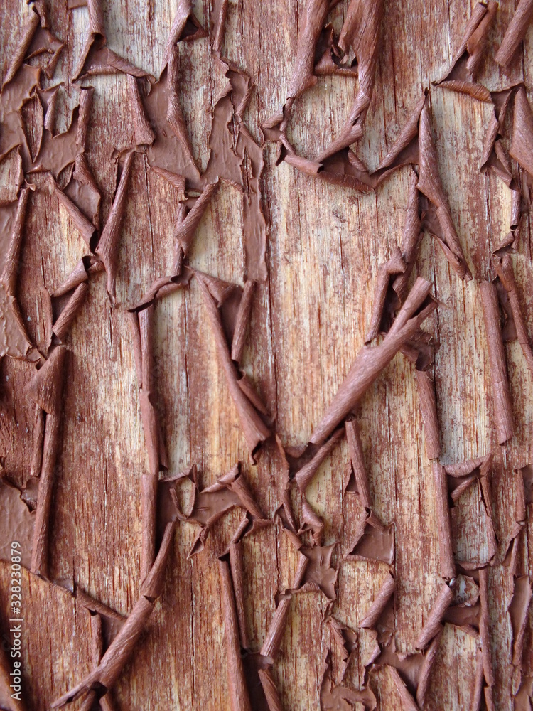 macro image of a wooden wall with cracked brown paint macro image of a wooden wall with cracked brown paint
