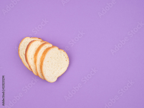 Sliced white bread on a purple background. photo