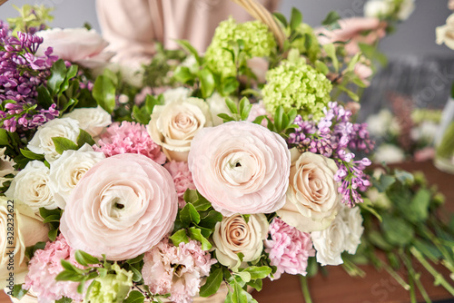 Spring bouquet in a wicker basket.. Learning flower arranging  making beautiful bouquets with your own hands. Flowers delivery