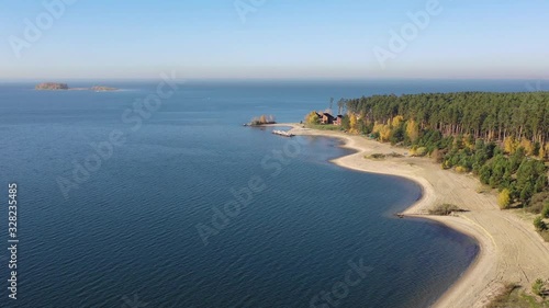 Autumn landscape with yellow forest on the shore of Ob sea and town Akademgorodok on background. photo