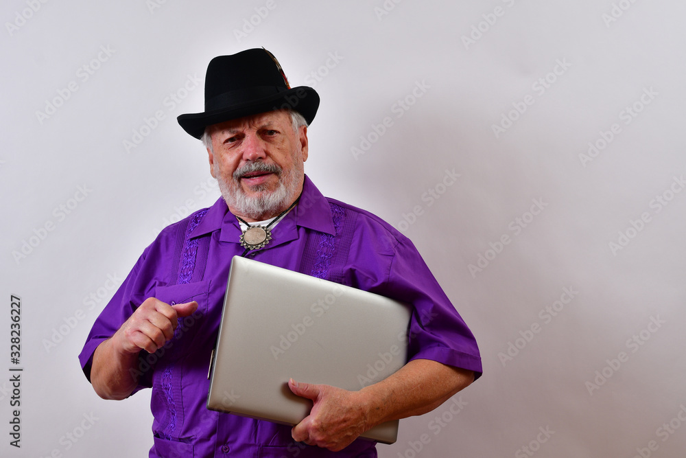 Elegant old man holding his closed laptop computer. Elegant old man holding his closed laptop computer.