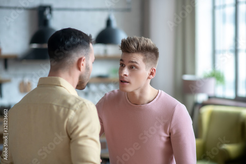 Two young men having an argument and looking agressive
