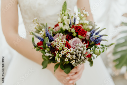 Bouquet of spring flowers in the hands of the bride